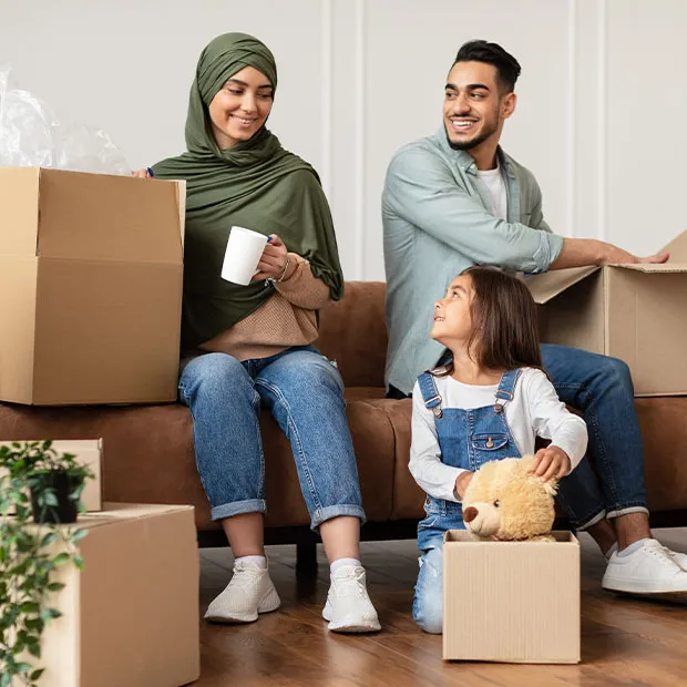 A young family packing their belongings, getting ready to move to a new home.