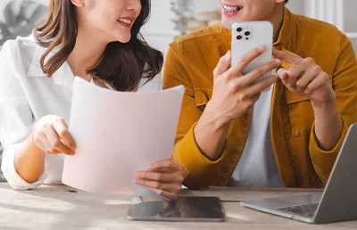 A mother and son discussing their utility bills and trying to make payments online.