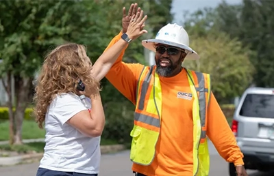 OUC line worker giving a customer a high-five